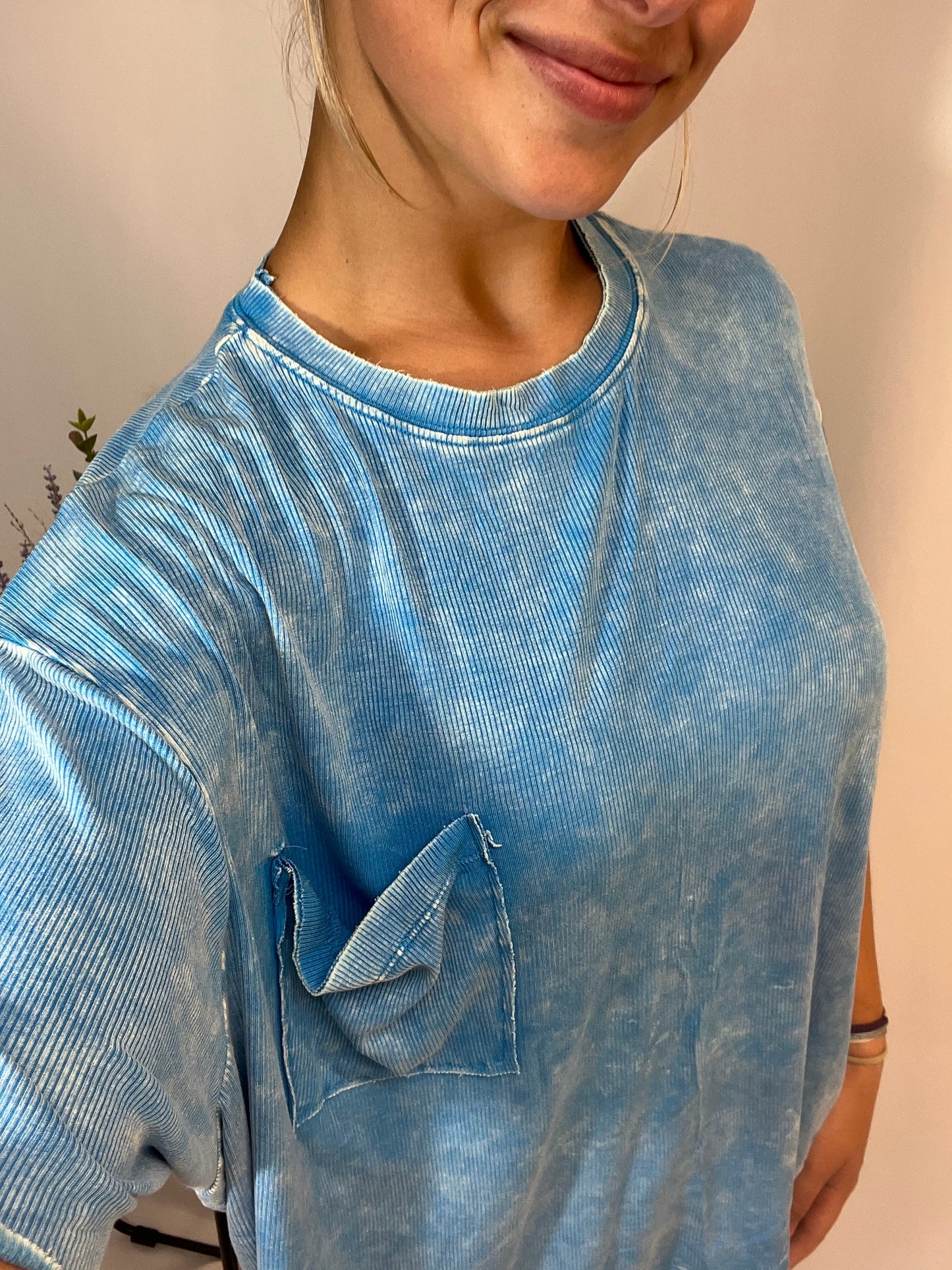 Laid-back style sky blue tee with chest pocket and relaxed silhouette close up detail