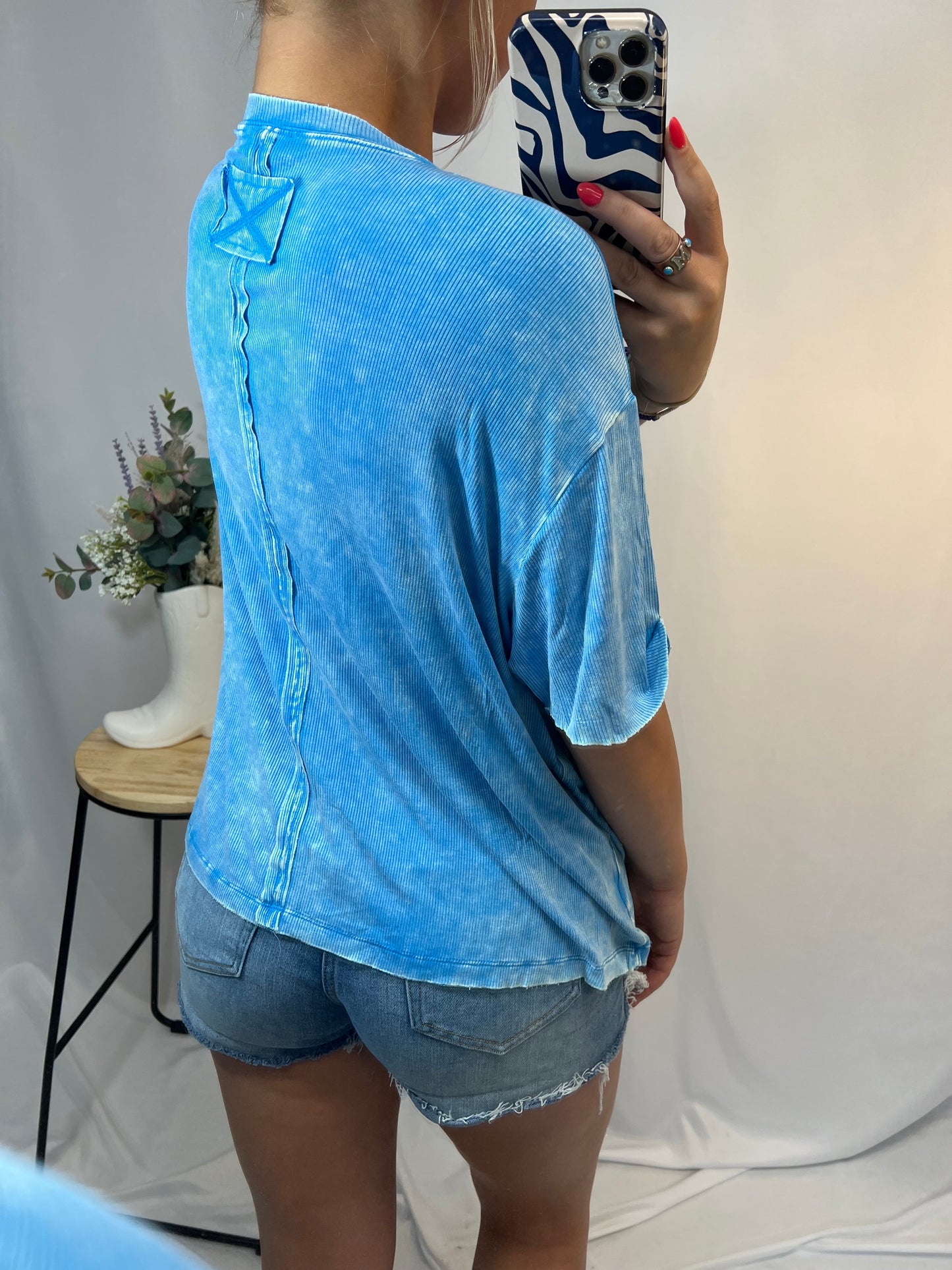 Young woman wearing vintage-inspired sky blue oversized tee with casual fit
