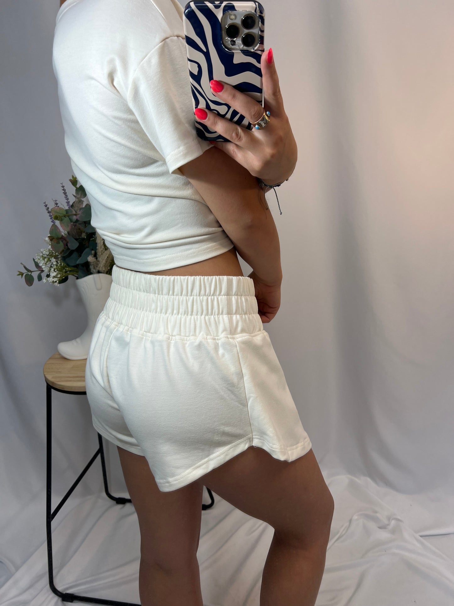 Side view of ivory skort shorts detail with cropped matching tee