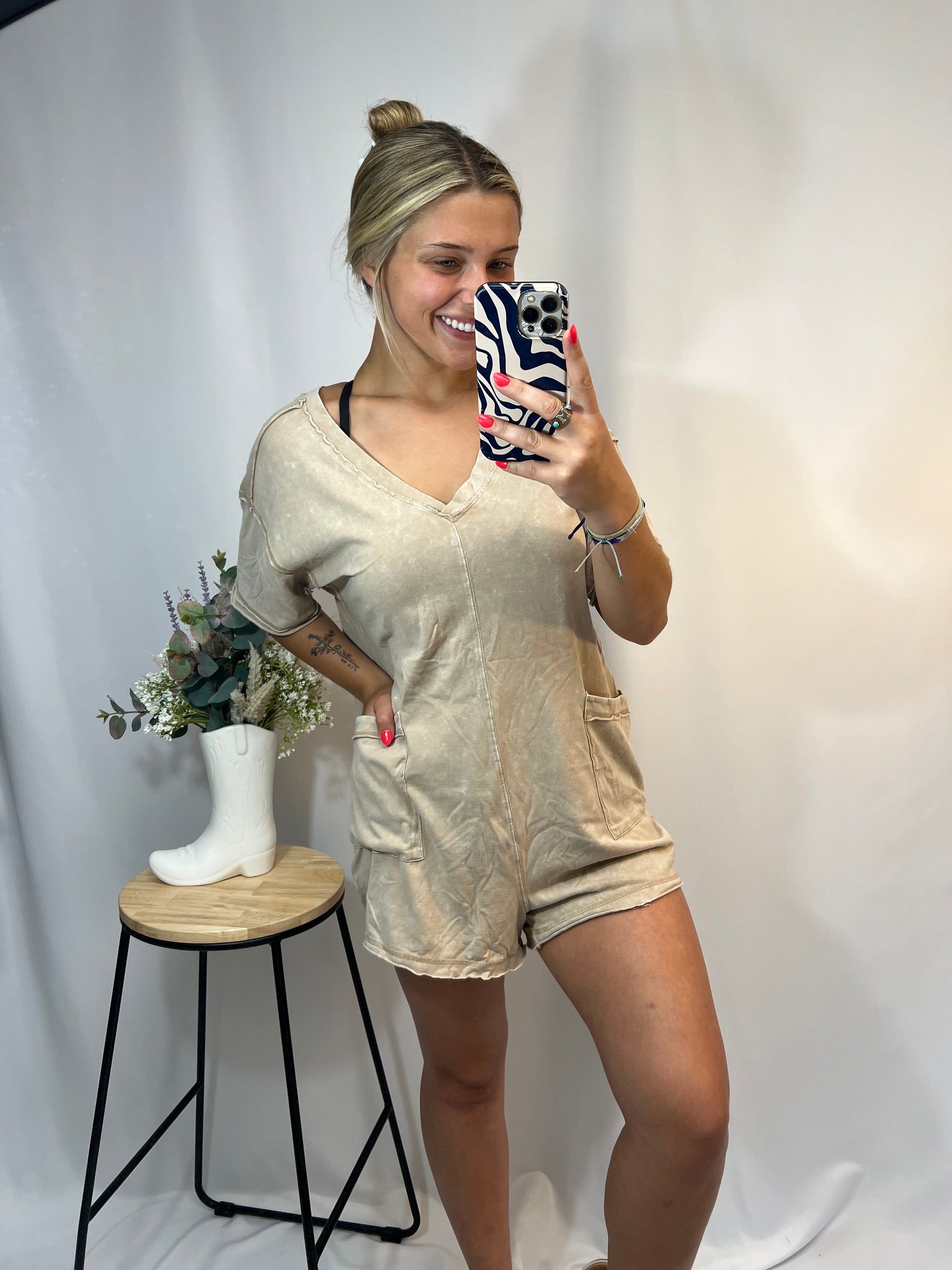 Young woman modeling taupe oversized romper with casual summer look