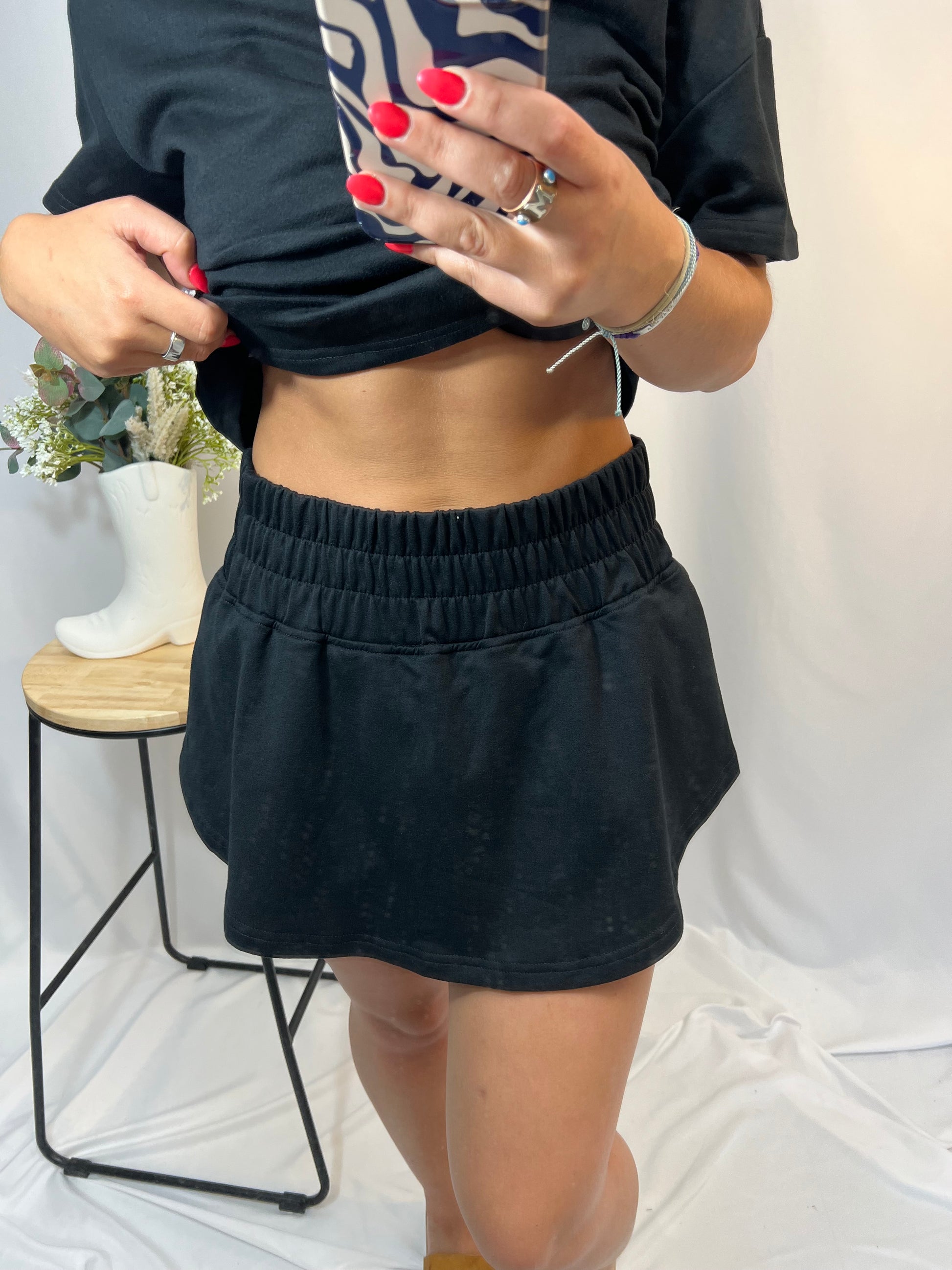Close-up of black athletic skort with built-in shorts under skirt overlay