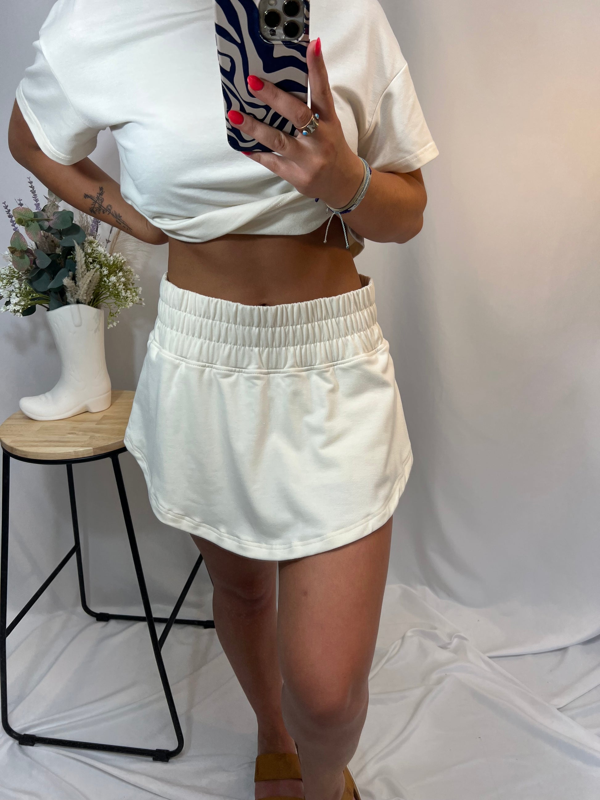 Close-up of ivory high-rise ruffle skort with stretchy waistband