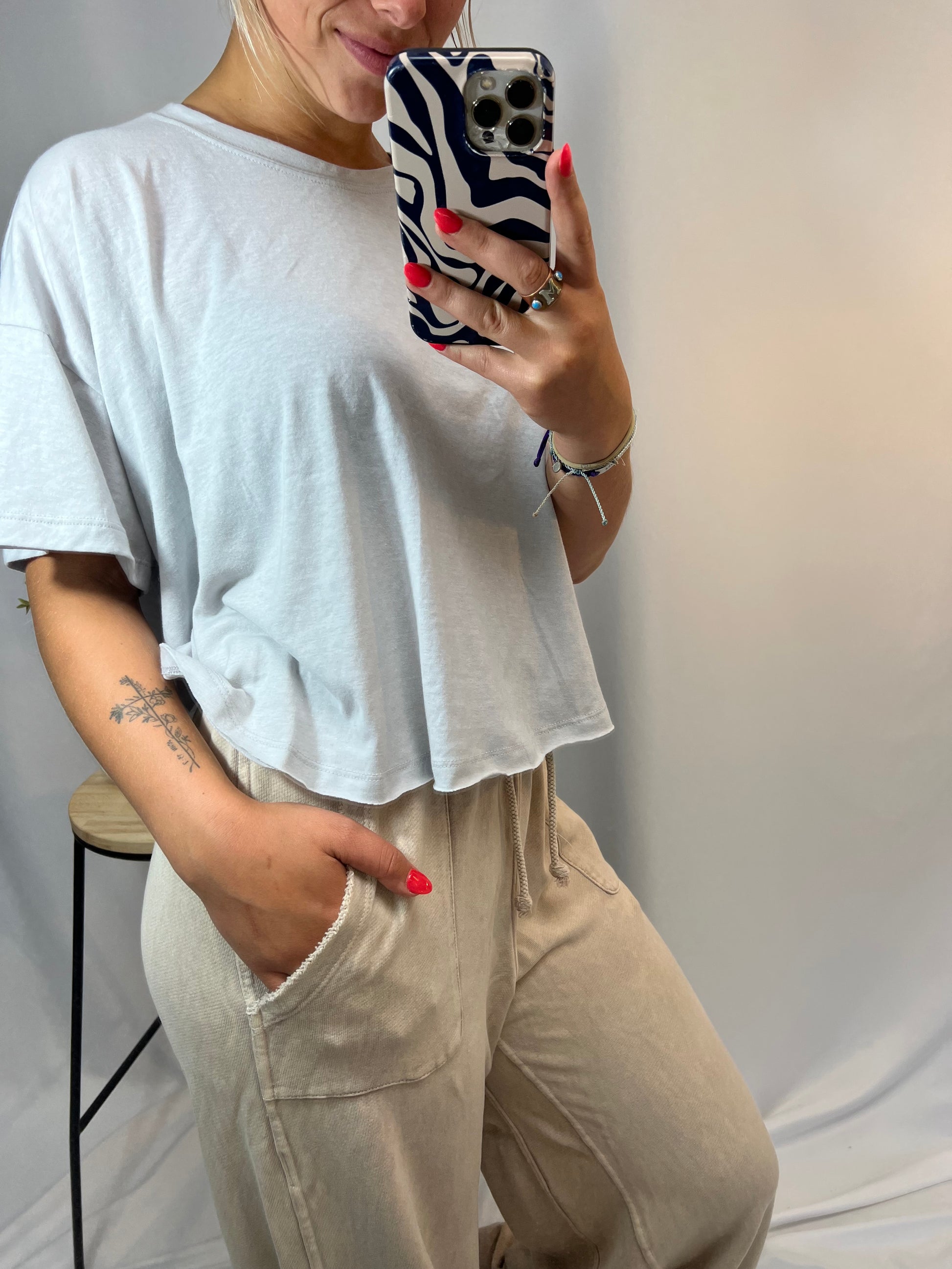 Side view of high-waisted French terry lounge pants in beige with deep front patch pockets
