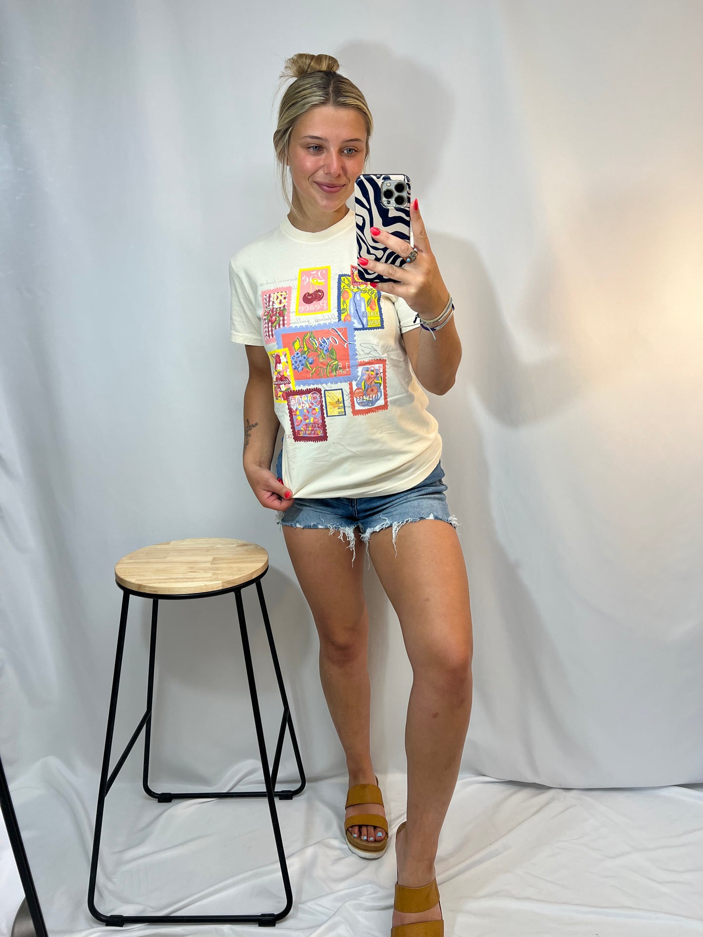 Girl wearing Fruit of the Spirit graphic tee in natural color – Comfort Colors Christian shirt with vintage stamp artwork, styled with denim shorts