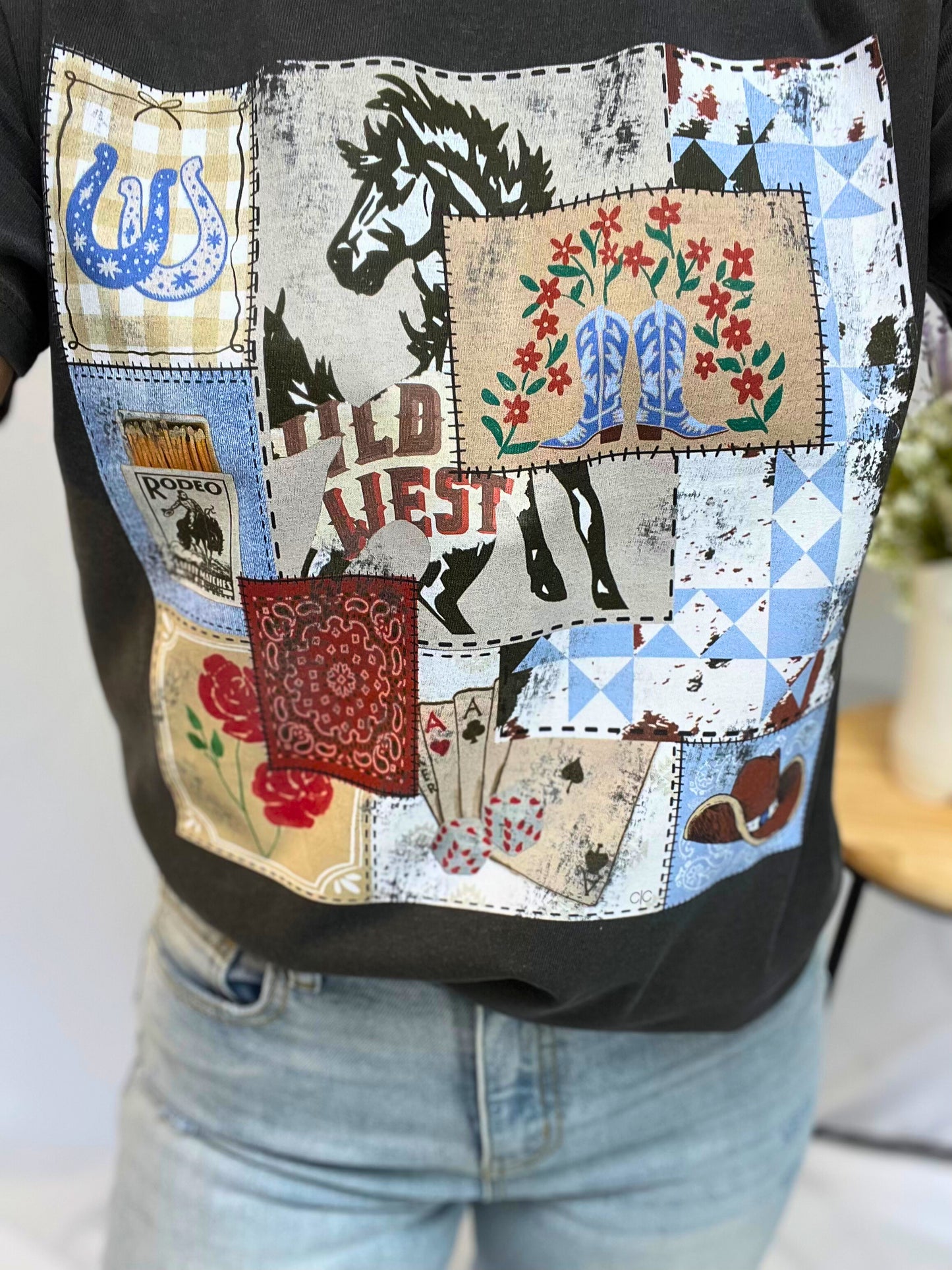Close-up of Rodeo Patch Tee’s vintage rodeo stamps graphic print on soft cotton — western tee for girls with cute cowgirl style.