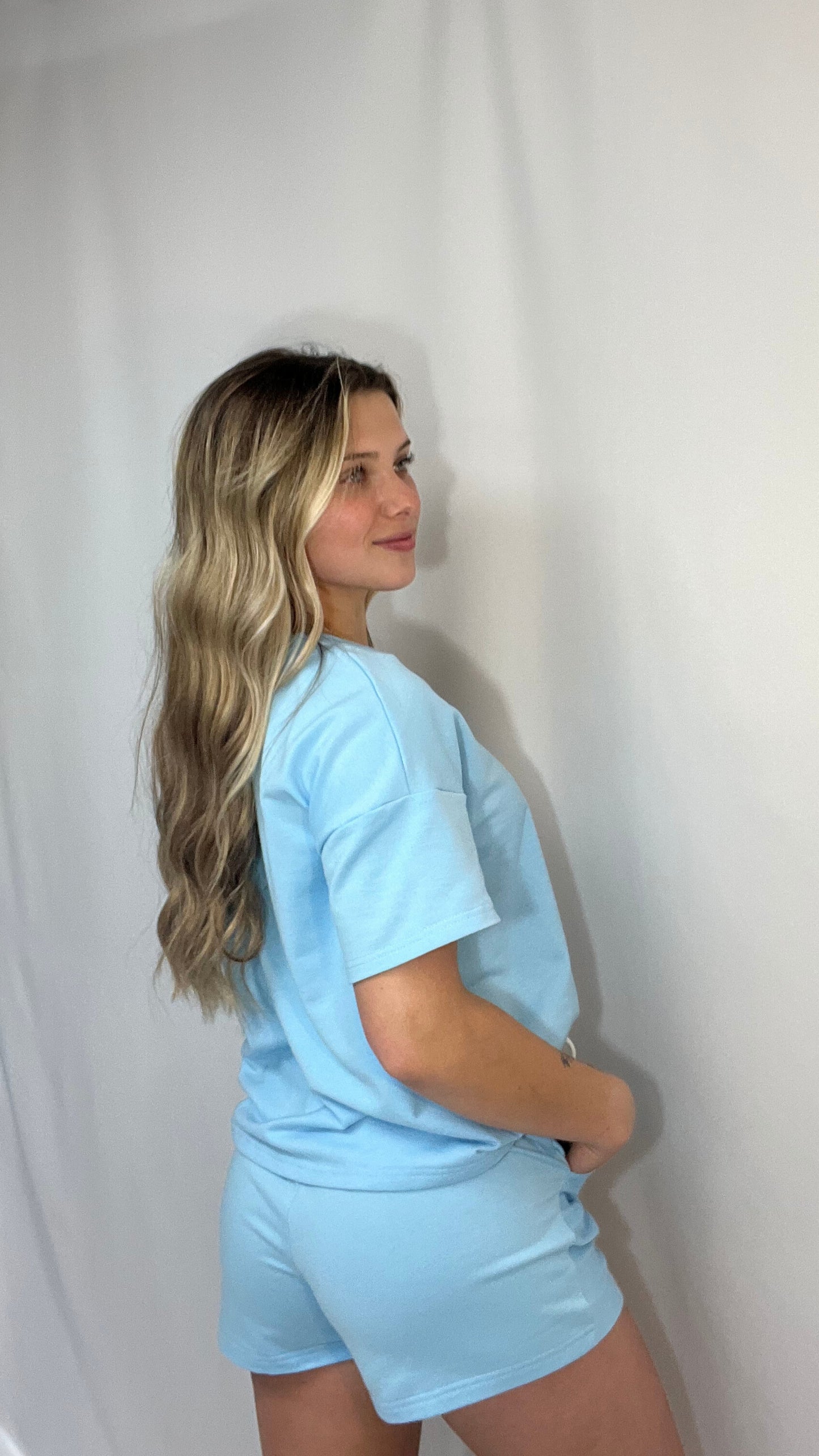 Back view of matching sky blue lounge set with v-neck top and high-rise drawstring shorts