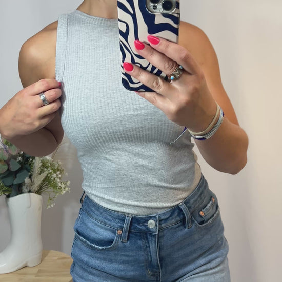 Close-up of soft ribbed fabric tank top with high neckline in grey color
