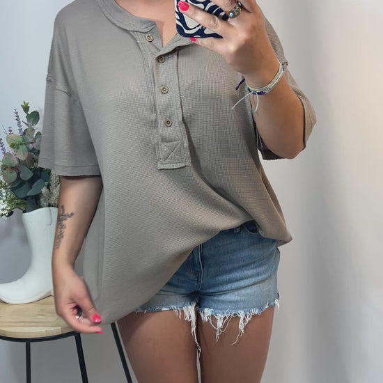 Try-on video of oversized taupe Henley waffle knit tee with distressed denim shorts — comfy neutral outfit for girls