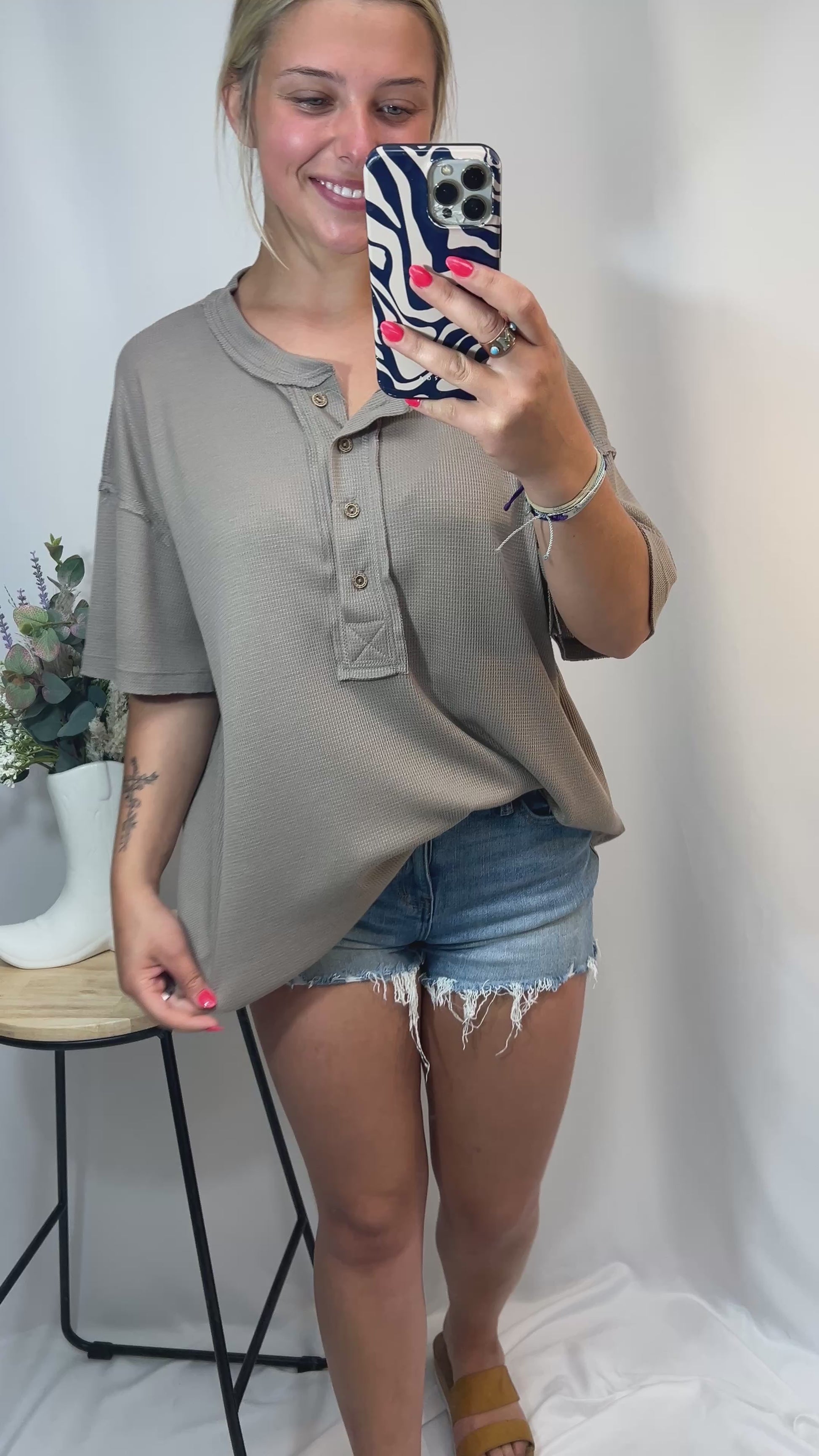 Try-on video of oversized taupe Henley waffle knit tee with distressed denim shorts — comfy neutral outfit for girls