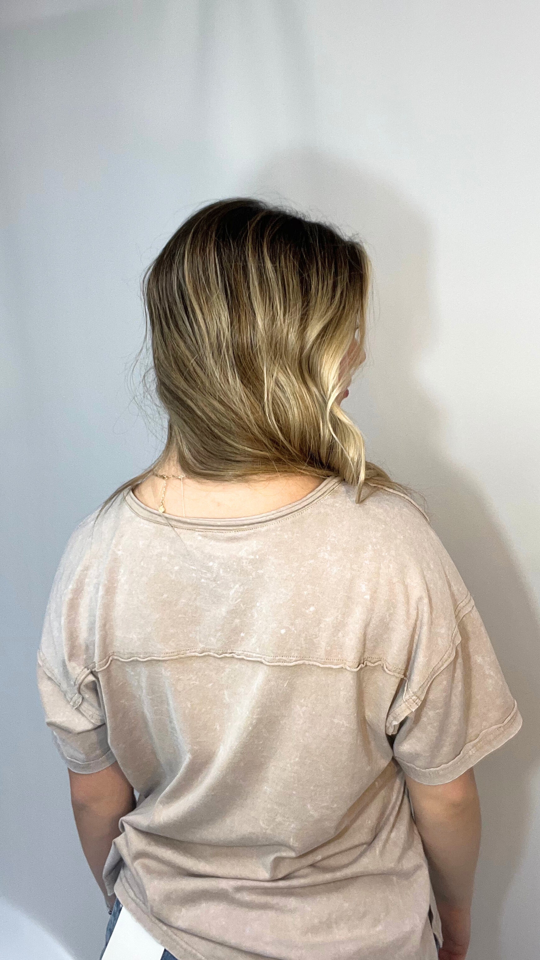 Woman modeling mineral washed taupe tee with v-neck and chest pocket for summer look